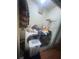 Laundry room with washer, dryer, supplies, and dirty clothes at 8203 N Semmes St, Tampa, FL 33604