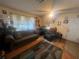 Cozy living room with hardwood flooring, natural light and comfortable seating at 8203 N Semmes St, Tampa, FL 33604