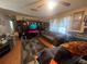 Inviting living room featuring hardwood floors, a ceiling fan, and natural light at 8203 N Semmes St, Tampa, FL 33604