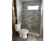 Modern bathroom shower featuring updated gray marble-patterned tiling, and updated glass shelves at 844 Bruce Ave, Clearwater Beach, FL 33767