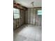 Kitchen features tile flooring, exposed wall studs, and a pair of windows for natural light at 844 Bruce Ave, Clearwater Beach, FL 33767