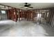 Open-concept living room featuring tiled flooring and exposed wooden framing; ceiling fan included at 844 Bruce Ave, Clearwater Beach, FL 33767