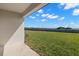 Large, fenced backyard with a well-maintained lawn and covered patio area, perfect for outdoor entertaining at 9066 Rally Spring Loop, Wesley Chapel, FL 33545