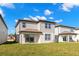 Grassy backyard showcases the home's exterior with siding and windows at 9066 Rally Spring Loop, Wesley Chapel, FL 33545