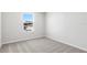 Bright bedroom with carpeting and a view to the neighborhood at 9066 Rally Spring Loop, Wesley Chapel, FL 33545