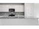 Modern kitchen featuring white cabinets, stainless steel appliances, and granite countertops at 9066 Rally Spring Loop, Wesley Chapel, FL 33545