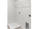 Laundry room has white walls, tile flooring, shelving, and hookups for a washer and dryer at 9066 Rally Spring Loop, Wesley Chapel, FL 33545