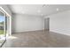 Spacious living room with tile flooring, recessed lighting, and sliding glass doors to the backyard at 9066 Rally Spring Loop, Wesley Chapel, FL 33545