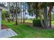 Lush backyard view with mature trees, green lawn, and defined landscaping, perfect for outdoor enjoyment and relaxation at 9500 Green Needle Dr, New Port Richey, FL 34655