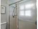 Bathroom featuring tiled shower with frosted glass door at 9500 Green Needle Dr, New Port Richey, FL 34655