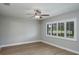 Bedroom features shuttered window and ceiling fan at 9500 Green Needle Dr, New Port Richey, FL 34655
