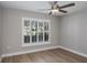 Bedroom with ceiling fan and shuttered window at 9500 Green Needle Dr, New Port Richey, FL 34655