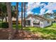 Back of house with screened in porch and trees at 9500 Green Needle Dr, New Port Richey, FL 34655