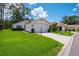 Charming single-story home featuring a well-manicured lawn and an attached two-car garage at 9500 Green Needle Dr, New Port Richey, FL 34655