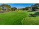 Expansive, well-maintained golf course featuring mature trees and meticulously manicured greens at 9500 Green Needle Dr, New Port Richey, FL 34655