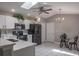 Updated kitchen featuring stainless steel appliances, white cabinetry, and an adjacent breakfast nook at 9500 Green Needle Dr, New Port Richey, FL 34655