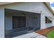 View of the screened-in lanai featuring outdoor seating and sliding glass doors at 9500 Green Needle Dr, New Port Richey, FL 34655