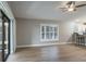Open living room features wood floors, fan, and slider to porch at 9500 Green Needle Dr, New Port Richey, FL 34655
