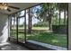 Relaxing screened patio offering serene views of the green backyard lawn and trees, bringing nature indoors at 9500 Green Needle Dr, New Port Richey, FL 34655