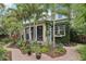Charming home with a lush backyard garden, brick path, and tropical landscaping at 1014 7Th Street N, St Petersburg, FL 33701