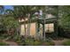 View of the lush backyard with palm trees, manicured plants, and a brick walkway at 1014 7Th Street N, St Petersburg, FL 33701