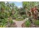 Backyard garden featuring a brick pathway, water feature, and tropical plants and landscaping at 1014 7Th Street N, St Petersburg, FL 33701