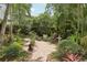 Brick pathway in lush backyard garden featuring tropical landscaping and serene setting at 1014 7Th Street N, St Petersburg, FL 33701