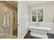 Bright bathroom featuring a standalone tub, marble wall, vanity, and glass enclosed shower at 1014 7Th Street N, St Petersburg, FL 33701
