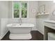 Bright bathroom featuring a standalone tub, marble wall, vanity, and natural light at 1014 7Th Street N, St Petersburg, FL 33701