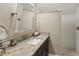 Bathroom featuring a granite counter top with a sink, a large mirror and a walk-in shower at 1014 7Th Street N, St Petersburg, FL 33701