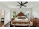 Stately bedroom featuring a detailed headboard, a ceiling fan, and natural light from the windows at 1014 7Th Street N, St Petersburg, FL 33701
