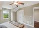 A bright bedroom featuring a window view, ceiling fan, and a convenient closet for ample storage at 1014 7Th Street N, St Petersburg, FL 33701
