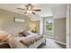 Inviting bedroom with neutral walls, plush carpeting, ceiling fan and window overlooking the lush landscaping at 1014 7Th Street N, St Petersburg, FL 33701