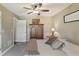 Charming bedroom features a ceiling fan, vintage wardrobe, neutral paint and a comfortable bed with decorative pillows at 1014 7Th Street N, St Petersburg, FL 33701