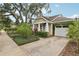 Inviting home exterior with a well-manicured lawn and a driveway leading to an attached garage at 1014 7Th Street N, St Petersburg, FL 33701