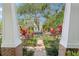 Inviting exterior shot of a home showcasing lush landscaping and a brick walkway at 1014 7Th Street N, St Petersburg, FL 33701