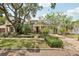 Charming home featuring a manicured front yard, mature trees, and beautiful landscaping at 1014 7Th Street N, St Petersburg, FL 33701