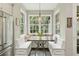 Kitchen nook features large picture window, built-in seating and table in a well-lit breakfast space at 1014 7Th Street N, St Petersburg, FL 33701