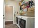 Spacious laundry room with washer, dryer, and shelving at 1014 7Th Street N, St Petersburg, FL 33701