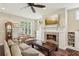 Comfortable living room featuring a fireplace with built-in shelving and a large window at 1014 7Th Street N, St Petersburg, FL 33701