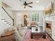 Bright living room with a stone fireplace, wooden floors, and a classic grandfather clock at 1014 7Th Street N, St Petersburg, FL 33701