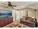 Cozy living room features a large flat screen television and comfortable brown sofa with throw pillows at 1014 7Th Street N, St Petersburg, FL 33701