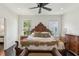 Comfortable bedroom with wood frame bed, wood floors, and natural light from the bright windows at 1014 7Th Street N, St Petersburg, FL 33701