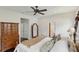 Comfortable bedroom featuring a ceiling fan, hardwood floors, and a full-length decorative mirror at 1014 7Th Street N, St Petersburg, FL 33701