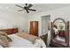 Comfortable bedroom featuring a ceiling fan, hardwood floors, and a full-length decorative mirror at 1014 7Th Street N, St Petersburg, FL 33701