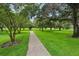 Picturesque park featuring a walking path, lush green grass, and mature trees at 1014 7Th Street N, St Petersburg, FL 33701
