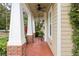 Covered porch featuring brick columns, a ceiling fan, and a brick floor at 1014 7Th Street N, St Petersburg, FL 33701