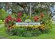 Crescent Lake Park sign surrounded by lush greenery and colorful plants at 1014 7Th Street N, St Petersburg, FL 33701