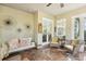 Comfortable sunroom with a hanging swing, rattan furniture and bright lighting at 1014 7Th Street N, St Petersburg, FL 33701