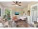 Cozy sunroom with a ceiling fan, rattan furniture and a swing, perfect for relaxation at 1014 7Th Street N, St Petersburg, FL 33701